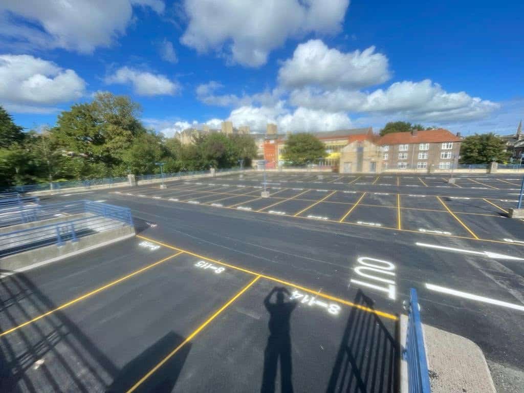 Large car park resurfaced with yellow bay lines and arrows