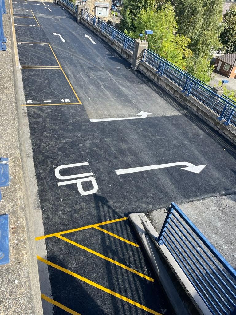 Car park ramp with new tarmac, UP marking and hatched yellow lines
