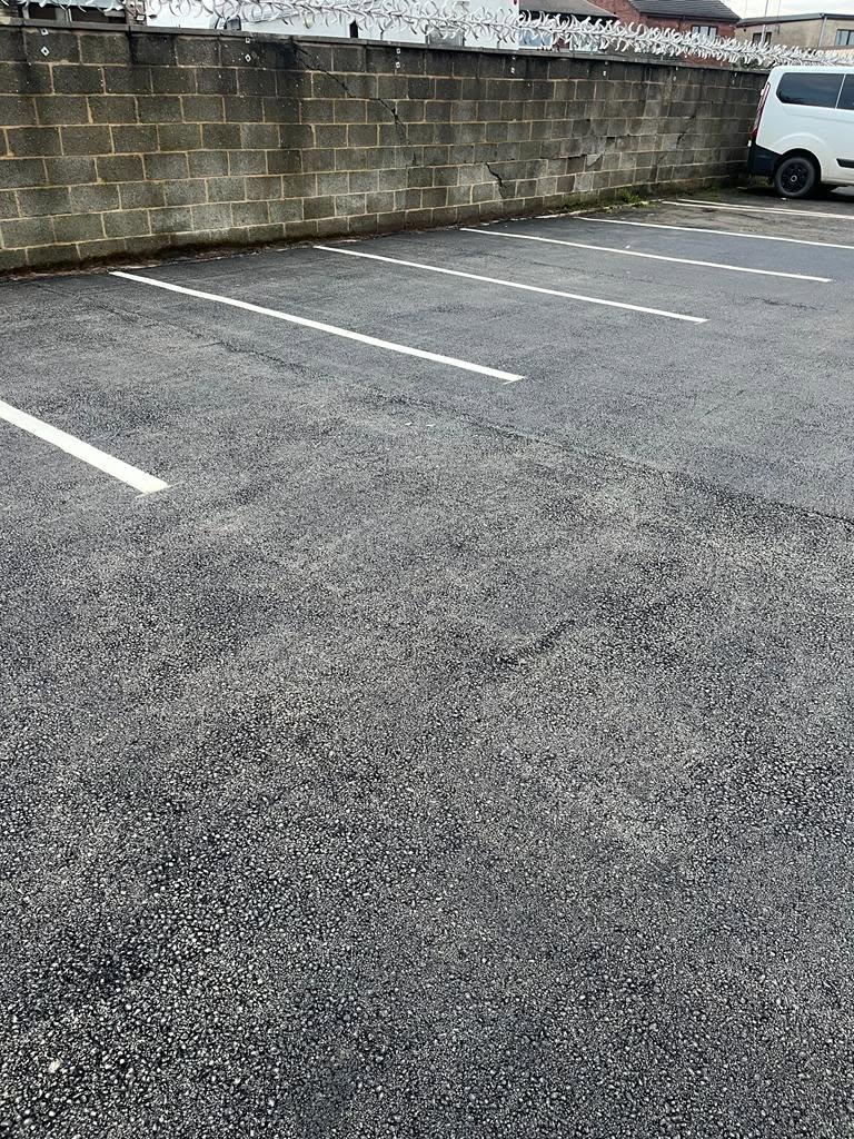 New tarmac and white bay lines in a commercial car park