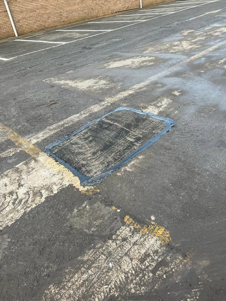 Tarmac patch repair on a worn road surface