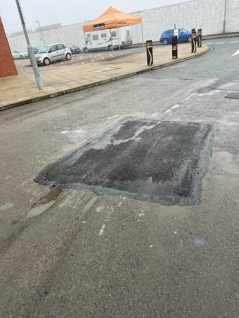 Large tarmac patch repair on a commercial road